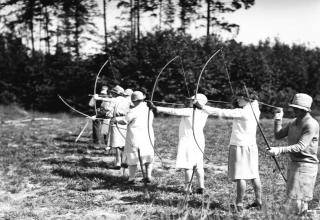 Beautiful ladies shooting bows.
