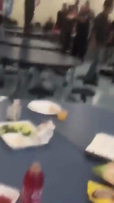 Bunch of students going wild in the cafeteria