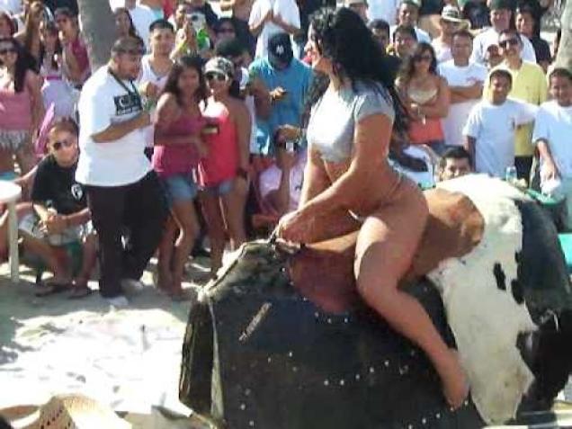 Hot girl riding mechanical bull.