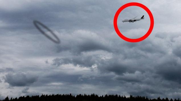 Airplane disappears in black circle in the sky
