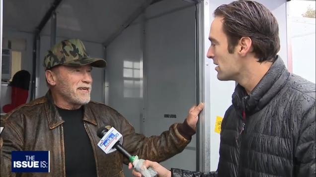 Arnold Schwarzenegger talking with Elex Michaelson of Fox 11 in one of the tiny homes he's donated