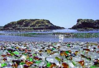 A beach's sand has been made entirely from recycled glass bottles.  Humans did not do the work to turn the bottles into sand that is capable of being walked on without hurting one's feet.  Nature did it.