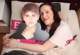 22 year Gabrielle Newton-Bieber is not only a crazy Justin Bieber fan, she even legally changed her name to his so she could pretend they were married. She sleeps next to a cardboard cut out of the star and has numerous Bieber related tattoos on her body in his honor.