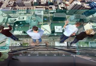 The Sears Tower rises 110 stories and 1450 feet above the Chicago skyline.  For those willing to enjoy the thrill of being 1300 feet in the air you can hop out into one of two enclosed glass boxes.  I think just looking at the pictures is enough for me.