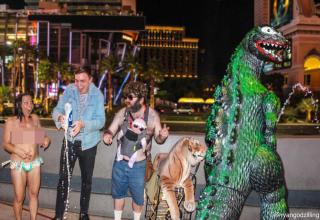 Guy travels with a giant plastic Godzilla he bought and $8 gave him priceless fun.