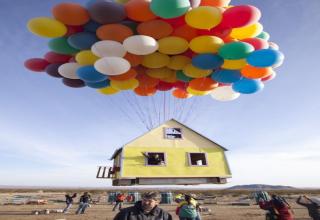 A group of men worked to recreate the classic Pixar film Up, by floating a house with giant balloons.